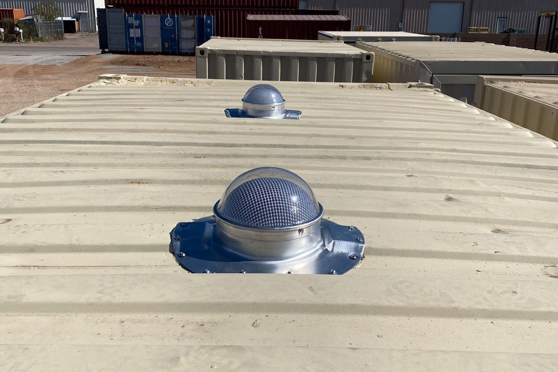 Two Conex Solar LightBlaster installed on a biege shipping container's roof which has 3.5" ribs. This is a customer's install photo.