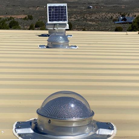 One Conex Solar Mega Roofblaster Adjustable and 2 Conex Solar LightBlasters installed on a beige shipping container's roof. This is a customer's install photo.