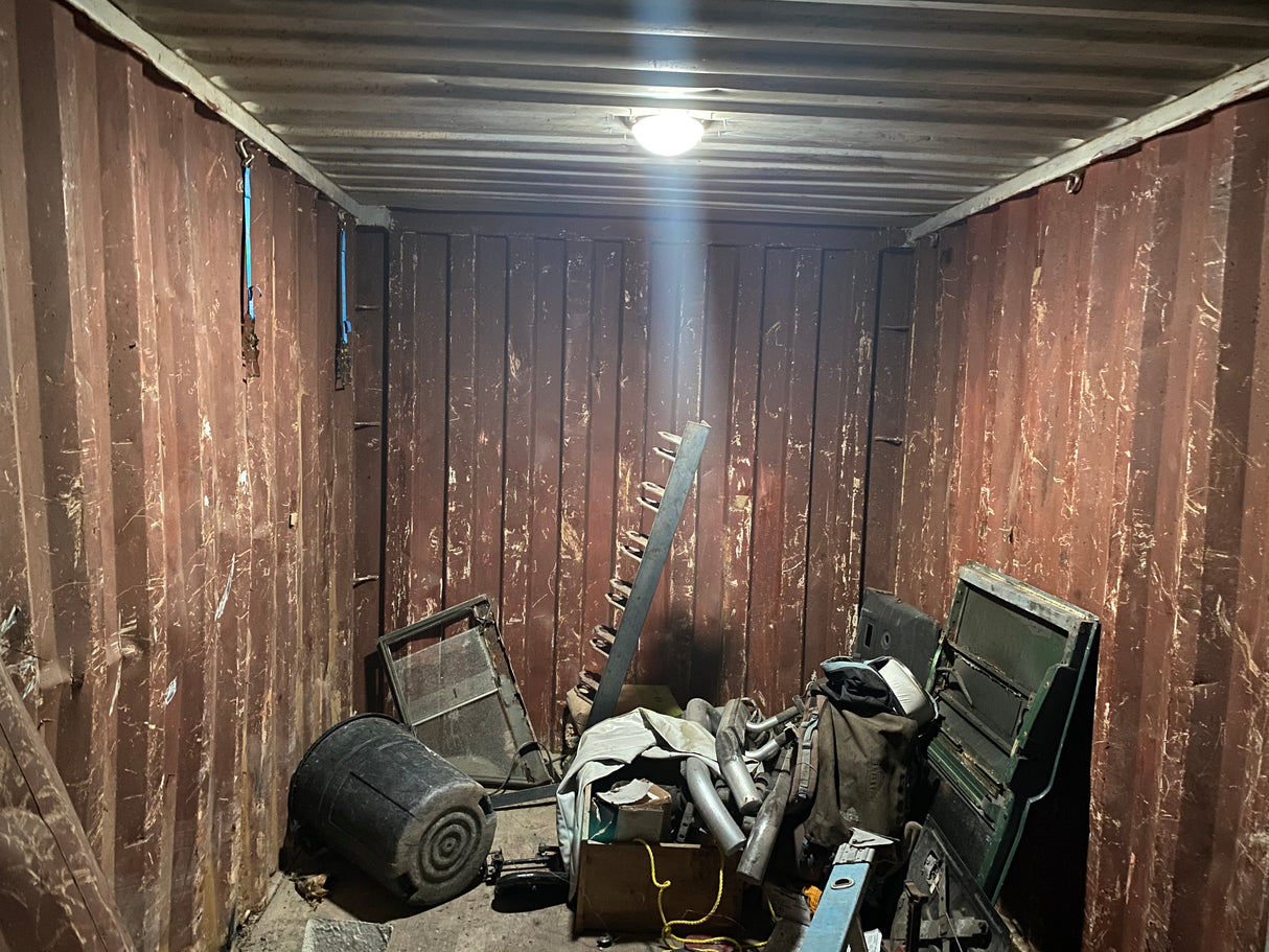 Inside view of a customer's brown shipping container that has light coming in from an installed Conex Solar LightBlaster tubular skylight.