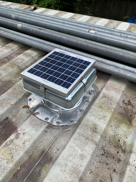 One Conex Solar Mega Roofblasters installed on a white shipping container's roof with pipes also on the roof. This is a customer's install photo.