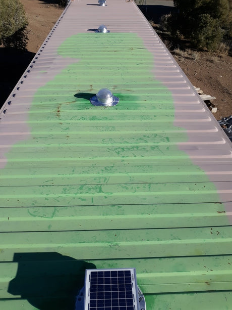 Two Conex Solar LightBlaster and two Conex Solar Mega RoofBlasters installed on a white/green shipping container's roof which has 3.5" ribs. This is a customer's install photo.