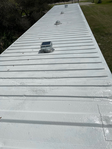Two Conex Solar Mega Roofblasters and 2 Conex Solar LightBlasters installed on a white shipping container's roof. This is a customer's install photo.