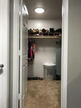 An after photo of a walk-in closet with a newly installed 10-inch Solar LightBlaster Tubular Skylight for Homes.