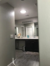 An after photo of a master bathroom with a newly installed 10-inch Solar LightBlaster Tubular Skylight for Homes.