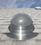 A 14" Solar LightBlaster Tubular Skylight for Homes installed on a gray shingled roof (flat roof model on a pitched roof with vaulted ceilings).