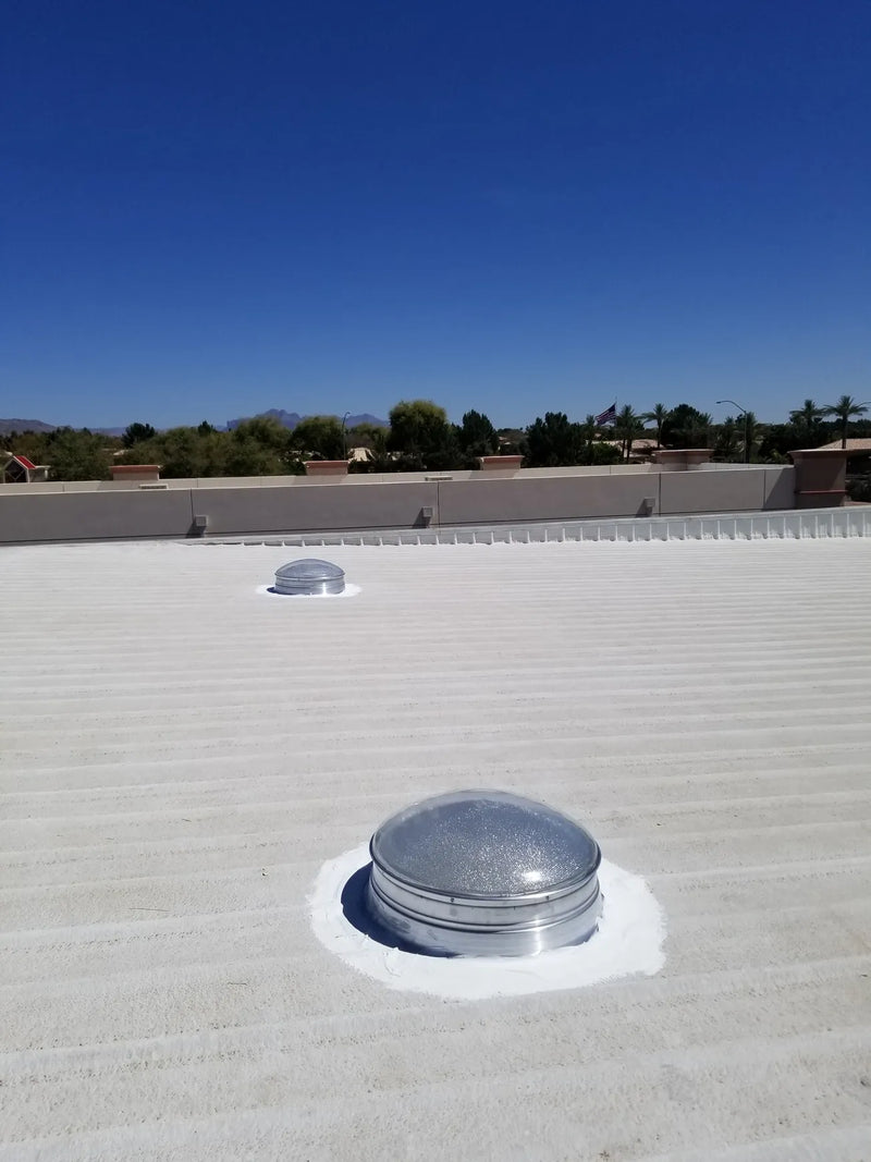 Two 28-inch Solar LightBlaster Tubular Skylights for Warehouses installed on a flat foam roof on top of a warehouse.