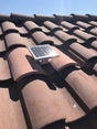 Solar S-TileBlaster installed on a roof that uses "S" style O'Hagin vent. The vent has been painted to match the rest of the tiles.
