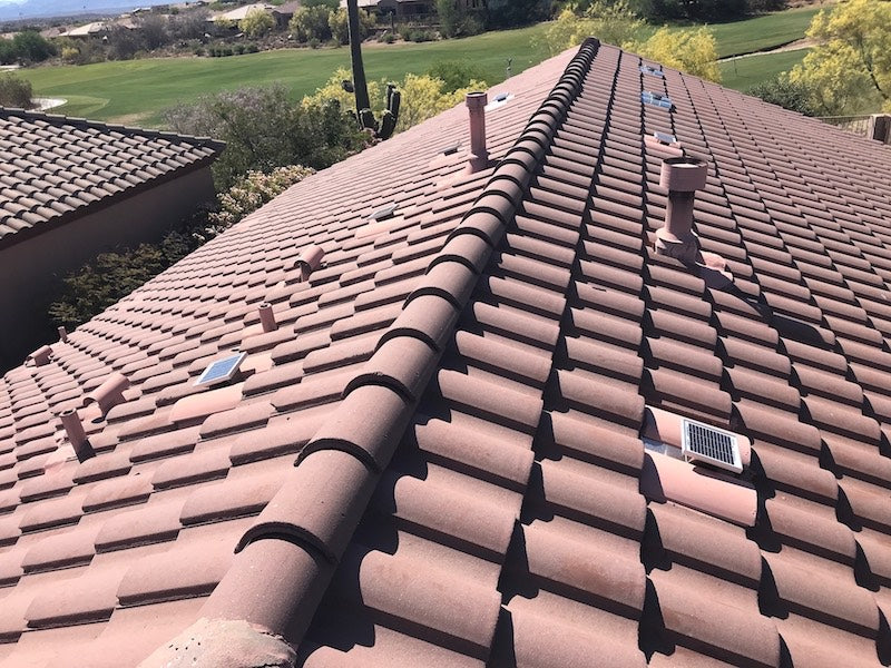 8 Solar S-TileBlaster have been installed on this tiled roof that uses "S" style O'Hagin vent. The vents closest have been painted to match the rest of the tiles. The ones farther away have not been painted yet so you still see the unpainted metal vents.