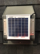 A weathered bronze Solar SlantBlaster vent is installed on a black shingled roof.