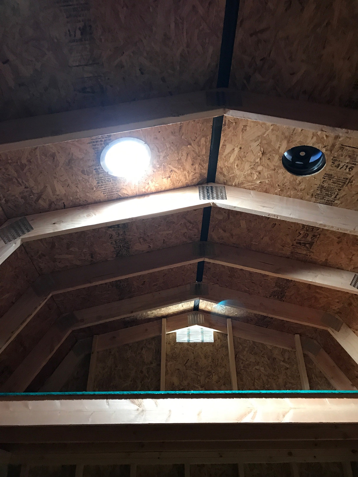 Ceiling of the inside of a shed where a customer installed a Solar LightBlaster tubular skylight and a Solar RoofBlaster vent.