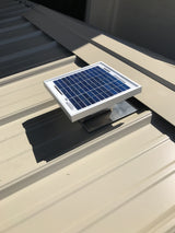 Solar Metal RidgeBlaster installed onto a shed's metal roof with the ridge cap being installed.
