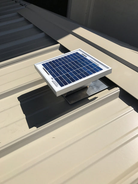 Solar Metal RidgeBlaster installed onto a shed's metal roof with the ridge cap being installed.
