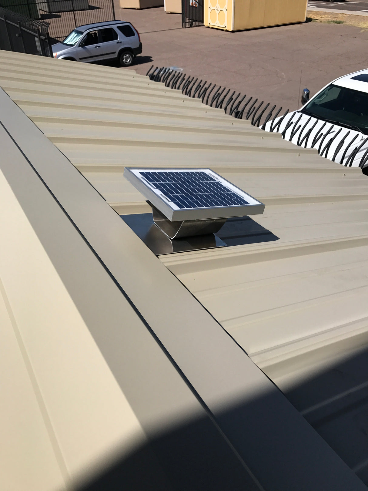Solar metal RidgeBlaster's solar panel installed on a metal roofed shed.
