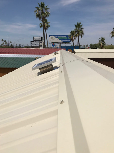 Solar Metal RidgeBlaster installed on a shed's beige metal roof.